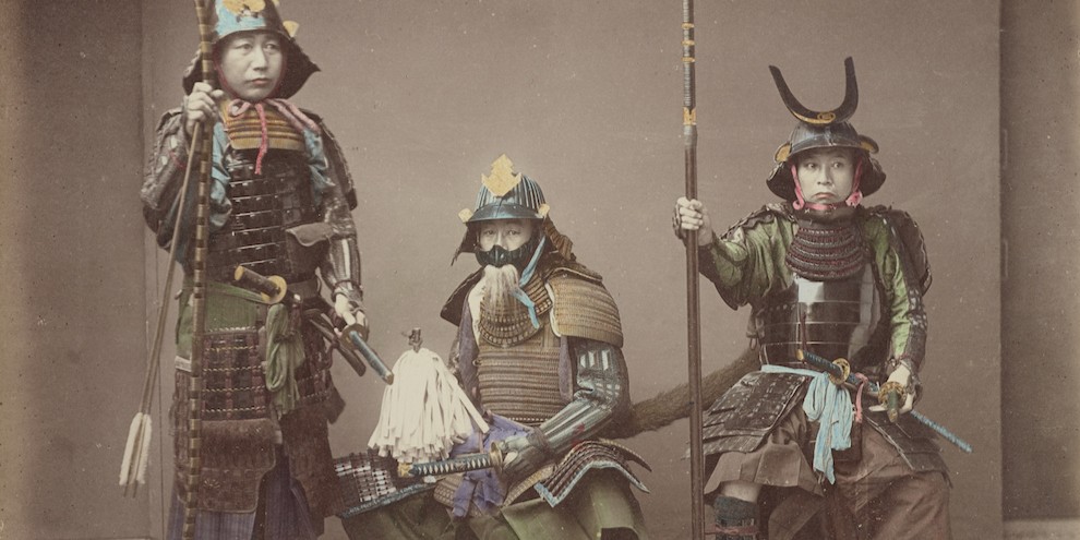 Colorized historical photo of three Japanese samurai in traditional armor.